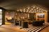 Sophisticated lounge area featuring modern lighting, plush seating, and elegant decor with cozy ambiance.
