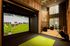 Luxurious apartment featuring a modern golf simulator room with plush seating, floor-to-ceiling windows, and contemporary interiors perfect for relaxation and entertainment.