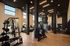 Spacious, well-lit gym with modern fitness equipment and sleek design elements.