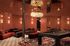 Luxurious lounge area with elegant chandelier, plush seating, and sophisticated pool table, perfect for entertainment and relaxation.