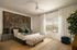 Elegant bedroom with lush green accents, large window offering scenic views, and stylish furnishings that include a chic bed and decorative rug.