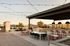 Elegant rooftop patio featuring modern seating, ambient string lights, and stunning sunset views.