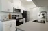 Sleek modern kitchen with stainless steel appliances, white cabinetry, and elegant countertops.