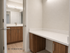 3D rendering of a modern bathroom with elegant wooden cabinets, sleek countertops, and a spacious vanity area.