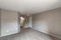 North Las Vegas, NV, Apartments with In-Unit Washer and Dryer - Topaz Springs - A Bedroom With Gray Walls, White Trim, And A Doorway Leading To A Bathroom.