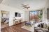 Apartments for Rent in North Las Vegas, NV - Desert Ridge - Cozy Living Room with Wood Plank Flooring, Ceiling Fan, and Furniture