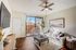 North Las Vegas, NV, Studios for Rent - Desert Ridge Apartments - Living Room With Sofa, Ceiling Fan, Coffee Table, and Glass Windows Overlooking the Private Patio and Outdoor View.