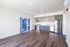 Dog-Friendly Apartments in West Oakland, CA - Prescott Station - Open-Concept Kitchen Features Two-Toned Cabinetry, Wood-Style Flooring, Stainless Steel Appliances, And Ceiling Lights.
