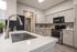 Westchase, TX, Apartments Near Beltway 8 - Gramercy Park - A Modern Kitchen With Light Wood Cabinets, Granite Countertops, And Undermount Sink With Gooseneck Faucet.
