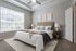 Dog-Friendly Apartments in Westchase, TX - Gramercy Park - A Bedroom With Matching Nightstands, Large Window With White Blinds, And Ceiling Fan.