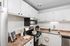 Two-Bedroom Apartments in Palatine, IL - The Clayson - A Compact Kitchen With White Cabinets, Stainless Steel Appliances, And A Sink