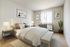 Two-Bedroom Apartments in Glendale Heights, IL - Ellyn Crossing Apartments - Bedroom With Upholstered Headboard, Crisp Bedding, Nightstand Lamps, and Sunny Window.