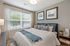 Bedroom with king sized bed and window
