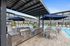 Outdoor grills and seating with blue umbrellas