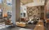 Luxurious open-concept living space with stylish modern furnishings, elegant chandeliers, and a feature wall showcasing art and decor.