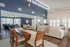 Open-concept community clubhouse with high ceilings, large windows, and elegant wooden furniture.