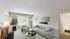 Bright and modern living room with a sleek sofa, stylish armchair, and a vibrant wall painting. Features a large window offering ample natural light and views of the greenery outside, complemented by a potted plant and a contemporary floor lamp.