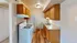 Inviting kitchen with wooden cabinets, modern appliances, and sleek countertops, perfect for culinary enthusiasts.
