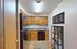 Charming kitchen featuring warm wooden cabinets, sleek black appliances, and stylish decor for modern living.