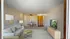 Inviting living room featuring a cozy sofa with decorative pillows, a stylish coffee table, and natural light enhancing the serene ambiance.