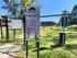 Inviting dog park entrance at Kimbrook Manor with welcoming sign and playful open green space, ideal for pet exercise and fun.