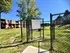 Inviting dog park with secure fencing in a lush green apartment complex, perfect for pet lovers seeking a vibrant community.