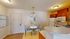 Charming kitchen featuring a cozy dining nook with elegant lighting, modern appliances, and stylish cabinetry.