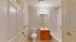 Elegant apartment bathroom with modern lighting, spacious vanity, and sleek bathtub, offering a serene and stylish space.