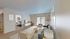 Bright, open-concept living room with modern decor, large windows, and cozy seating, perfect for relaxation and entertaining.