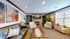Inviting living room with cozy fireplace, elegant leather sofa, and vibrant abstract artwork, perfect for relaxation.