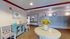 Inviting apartment lobby featuring elegant decor, floral arrangement on a round table, comfortable seating, and a wall of mailboxes for residents.