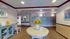 Inviting apartment lobby with elegant decor, featuring a vase of vibrant sunflowers, comfortable seating, and convenient mailboxes.