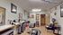 Cozy hair salon with stylish chairs, modern decor, and inviting wooden flooring, ideal for a relaxing beauty experience.