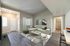 Inviting modern living room with elegant L-shaped sofa, stylish decor, and warm natural light, perfect for cozy gatherings.