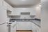 Charming kitchen with modern white cabinetry, sleek countertops, and a spacious layout for culinary creativity.