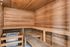 Inviting wooden sauna with warm wood tones, featuring spacious bench seating for a relaxing experience.