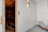 Luxurious apartment sauna with sleek wooden interiors and a comfortable lounge chair for ultimate relaxation.