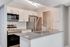 Modern kitchen with sleek stainless steel appliances, elegant countertops, and stylish white cabinetry.