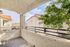 Charming balcony with stunning views, perfect for relaxation and enjoying fresh air amidst lush greenery and Mediterranean-style architecture.