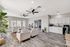 Bright, modern living space with cozy seating, sleek hardwood floors, and a stylish open kitchen.