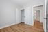 Modern bedroom with sleek white doors and stylish wood flooring, offering a spacious and bright interior.