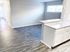 Bright open-concept living space with modern hardwood floors and sleek kitchen island, perfect for entertaining.