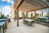 Luxurious outdoor amenity deck with stylish pergola, modern seating, and a sleek grilling area, perfect for relaxation and entertainment.
