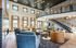 Elegant and spacious two-story living area with modern furnishings, vibrant decor, and abundant natural light.