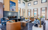 Bright, modern living room with high ceilings, luxurious furnishings, and a sleek fireplace, offering a cozy and inviting atmosphere.