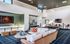 Luxurious apartment lounge with cozy seating, a modern fireplace, and stylish decor, ideal for relaxation and entertainment.