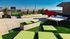 Rooftop lounge at our apartments for rent in Athens, featuring astroturf, a foosball table, and a view of the city of Athens