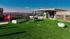 Rooftop lounge at our apartments for rent in Athens, featuring astroturf, a foosball table, and a view of the city of Athens