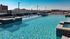 The pool at our student apartments for rent in Athens, featuring beach chairs, sparkling water, and a view of the city.
