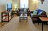 Living room with brown couches and blue pillow